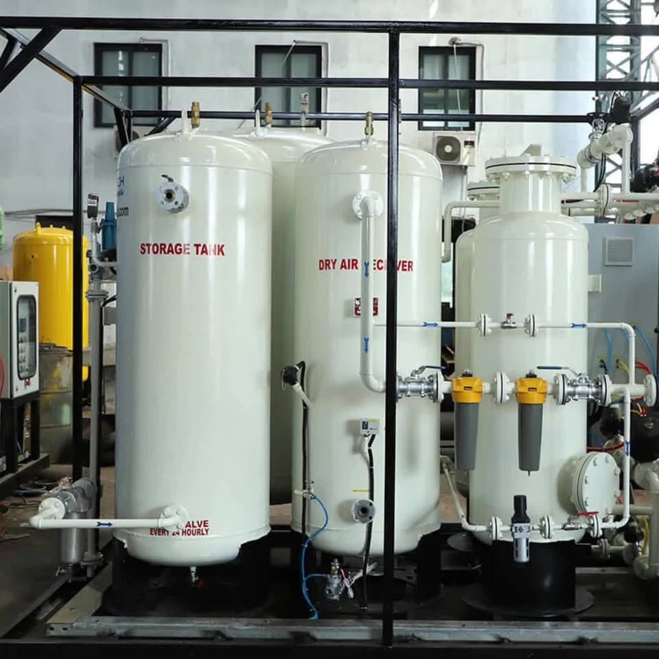 A wider view of the same plant, showing the compressor, yellow-capped filter housings and coloured control lines running between the vessels.